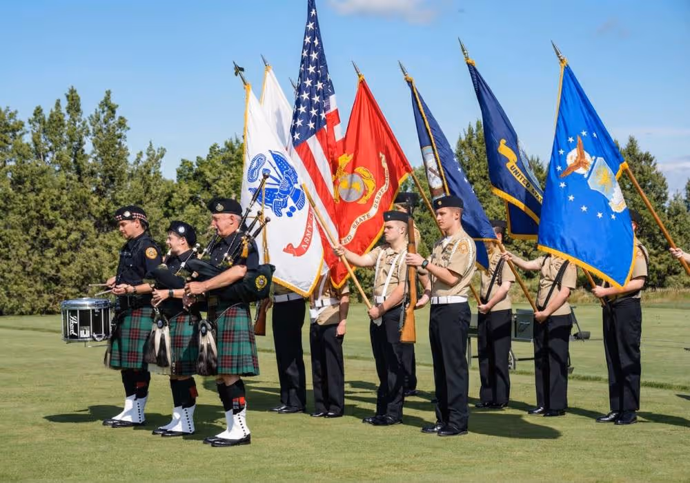 A group of men standing next to each other holding flags.