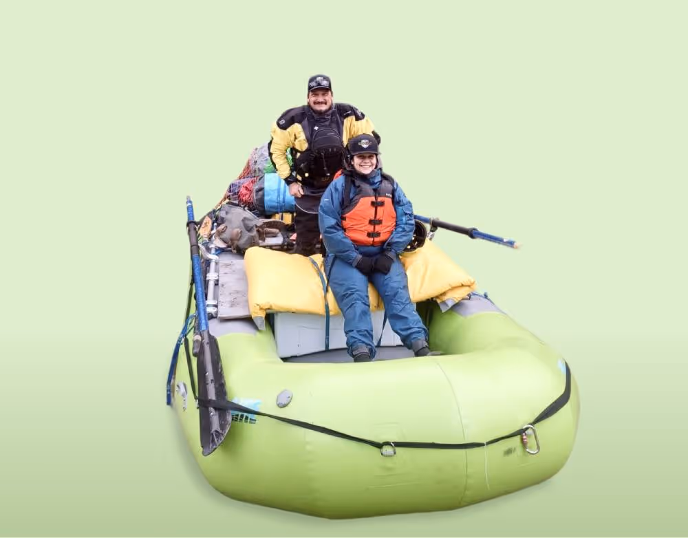 A group of people riding on the back of a raft.