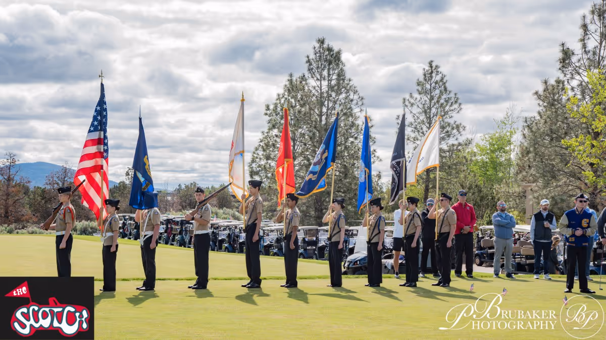 A group of men standing on top of a lush green field.