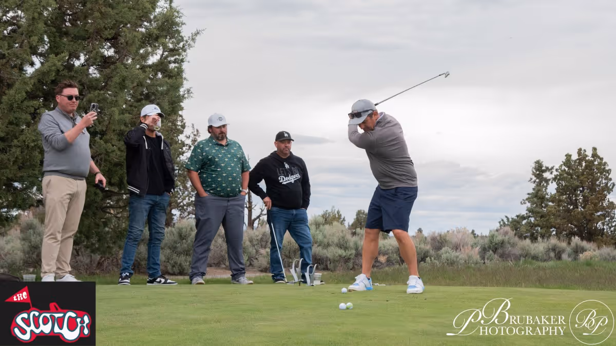 A group of men standing on top of a lush green field.