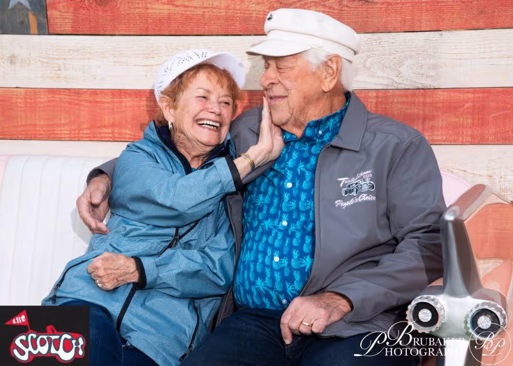 A couple of people that are sitting on a couch.