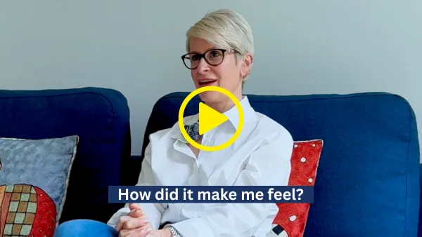 Woman with short blonde hair and glasses sitting on a blue couch with colorful pillows, captioned 'How did it make me feel?'