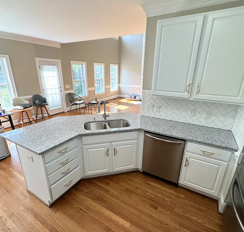 A kitchen that has had new countertops installed, along with a backsplash added