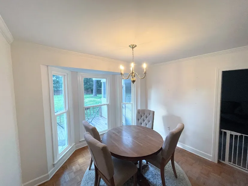 A small dining room area that has had the surrounding walls' drywall repaired and painted