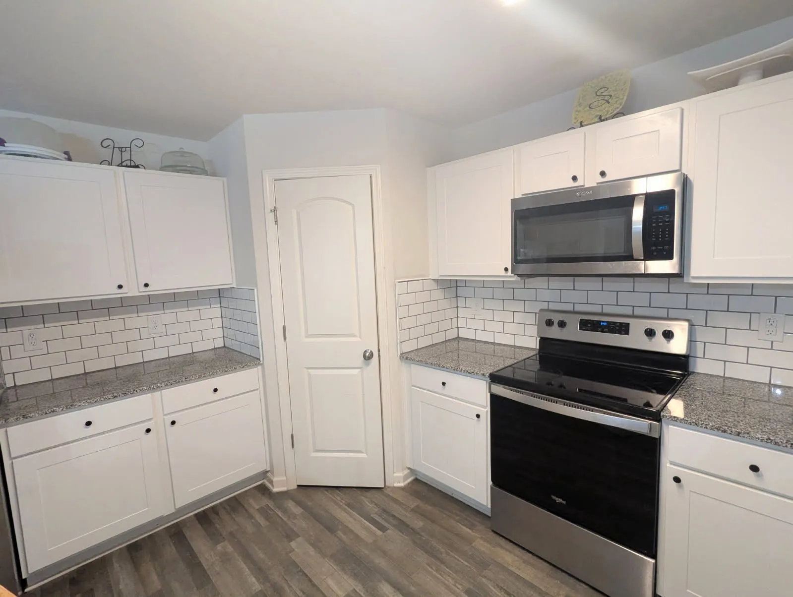 A white tile backsplash that has been installed in a Greenville, NC kitchen