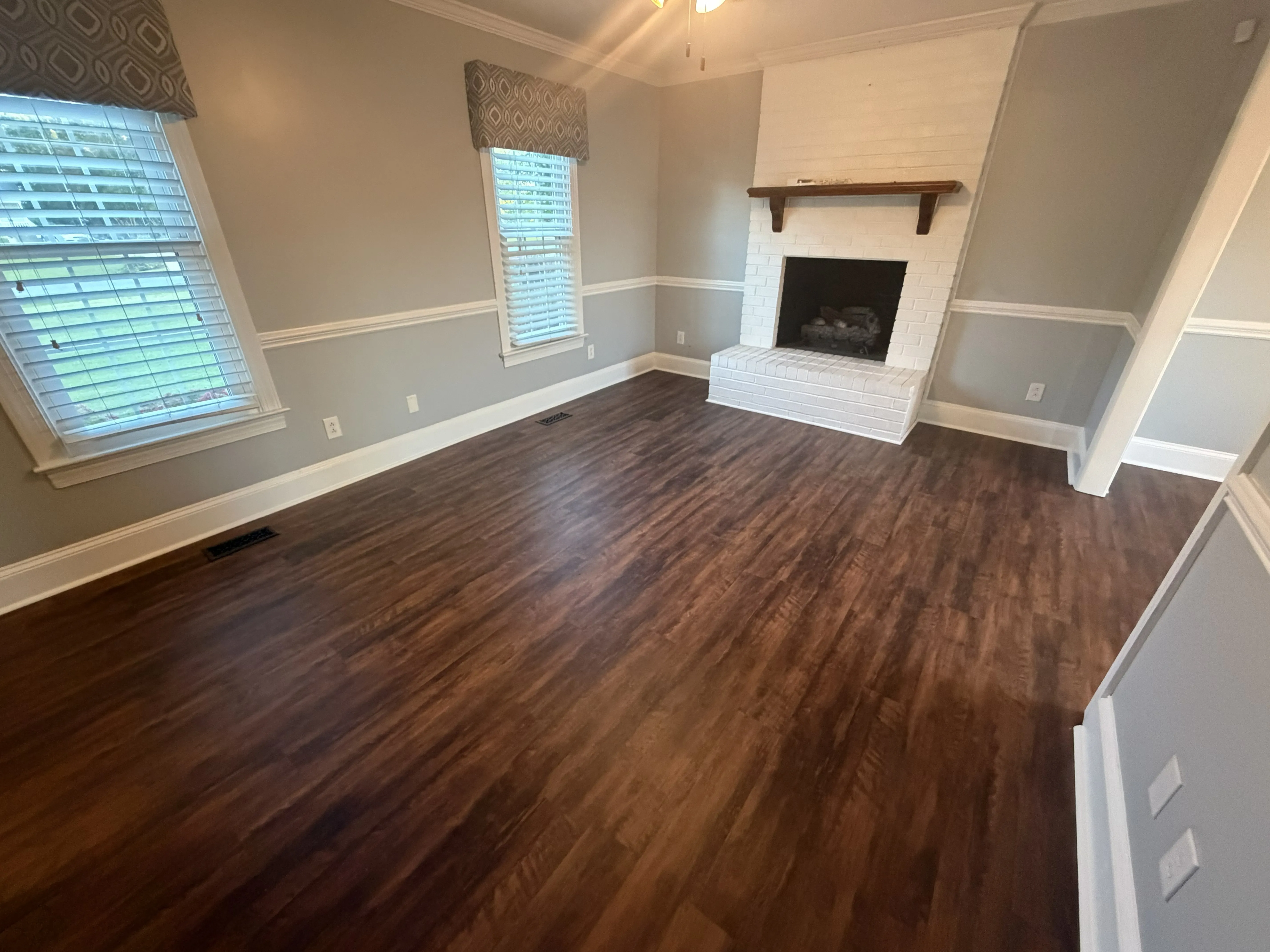 A hardwood floor that has been installed in a Greenville, NC home's living room by Unleashed Renovations