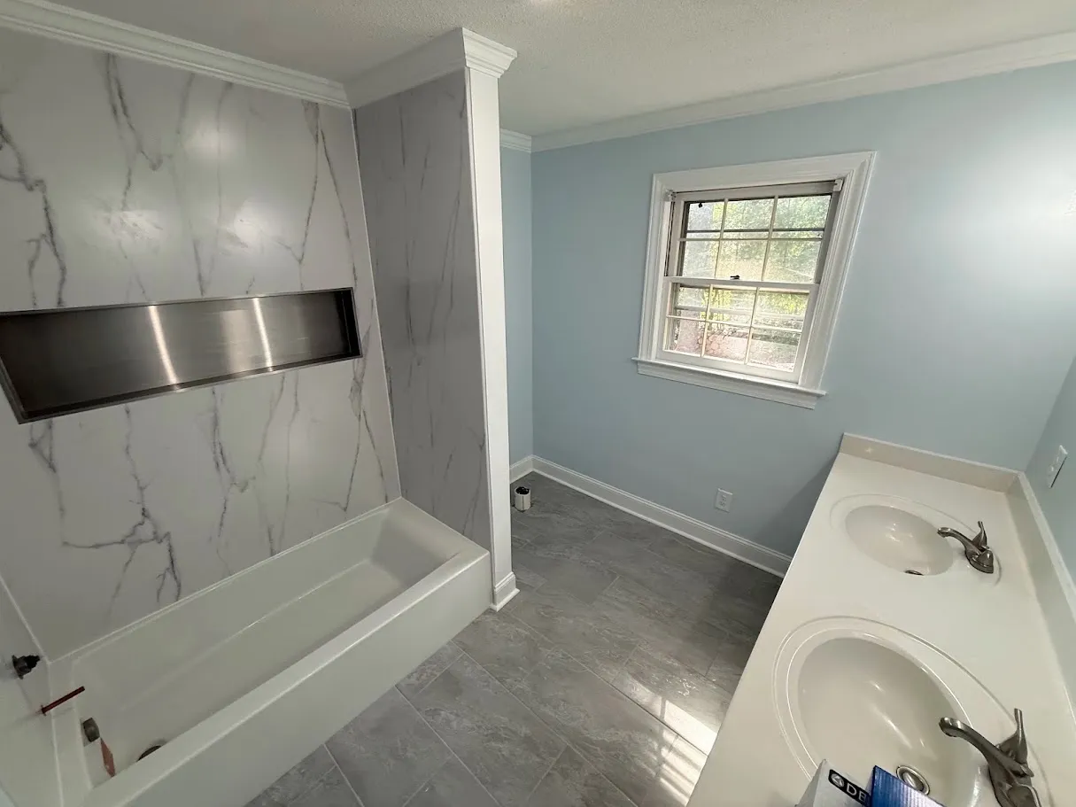 A standing shower that has been remodeled and renovated in a Greenville, NC bathroom by Unleashed Renovations
