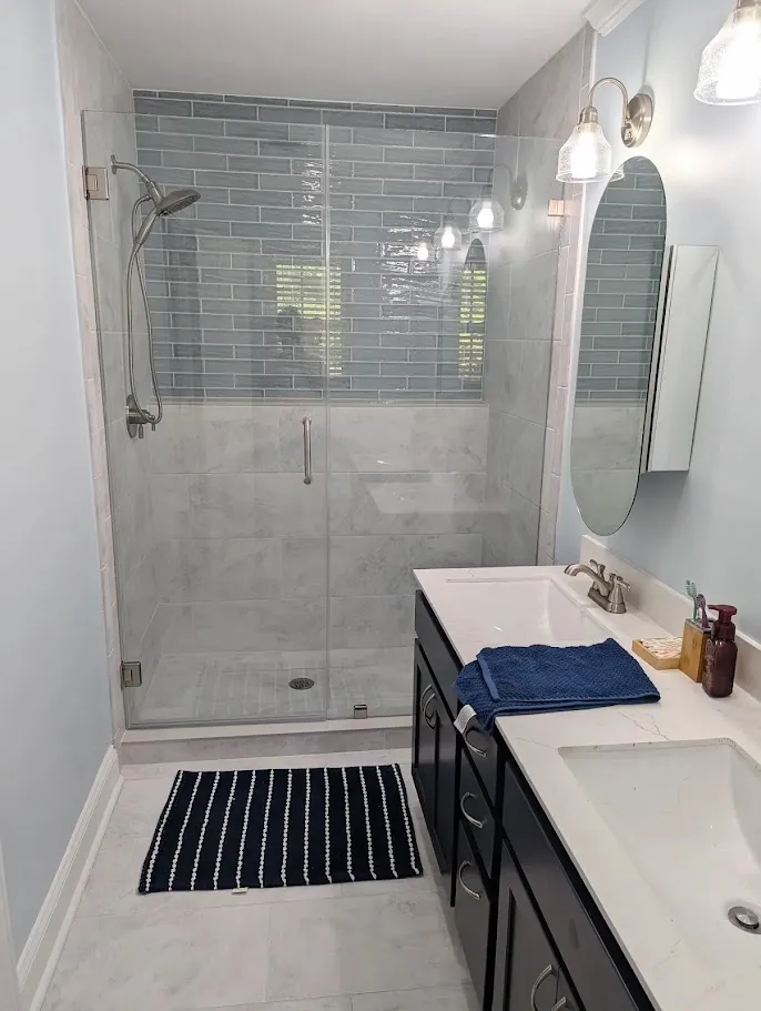 A standing shower that has been replaced and renovated by Unleashed Renovations in Greenville, NC