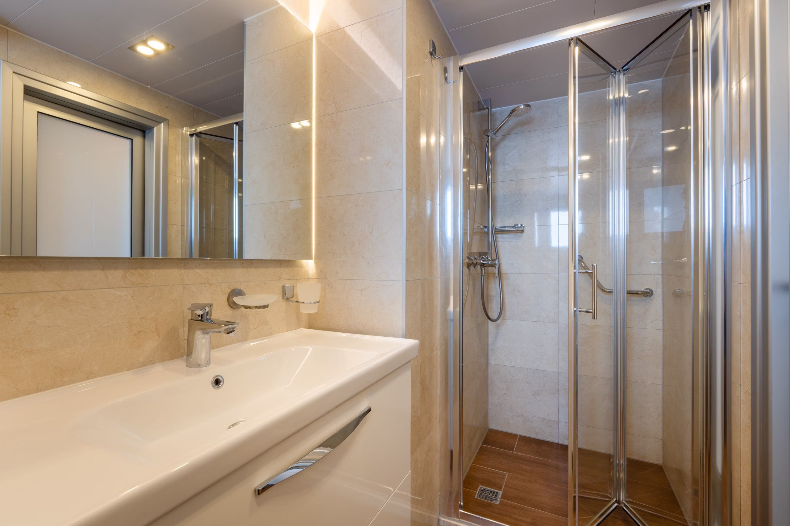 Cabin bathroom with glass shower and wide basin