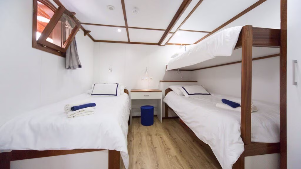 Cabin with two lower beds and an upper bunk
