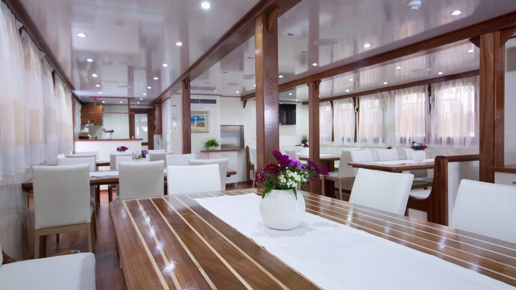 Dining tables with white chairs and fresh flowers