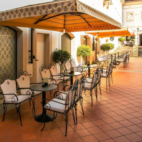 Hotel Jagerhorn outdoor terrace with bistro tables, parasols and terracotta tiles