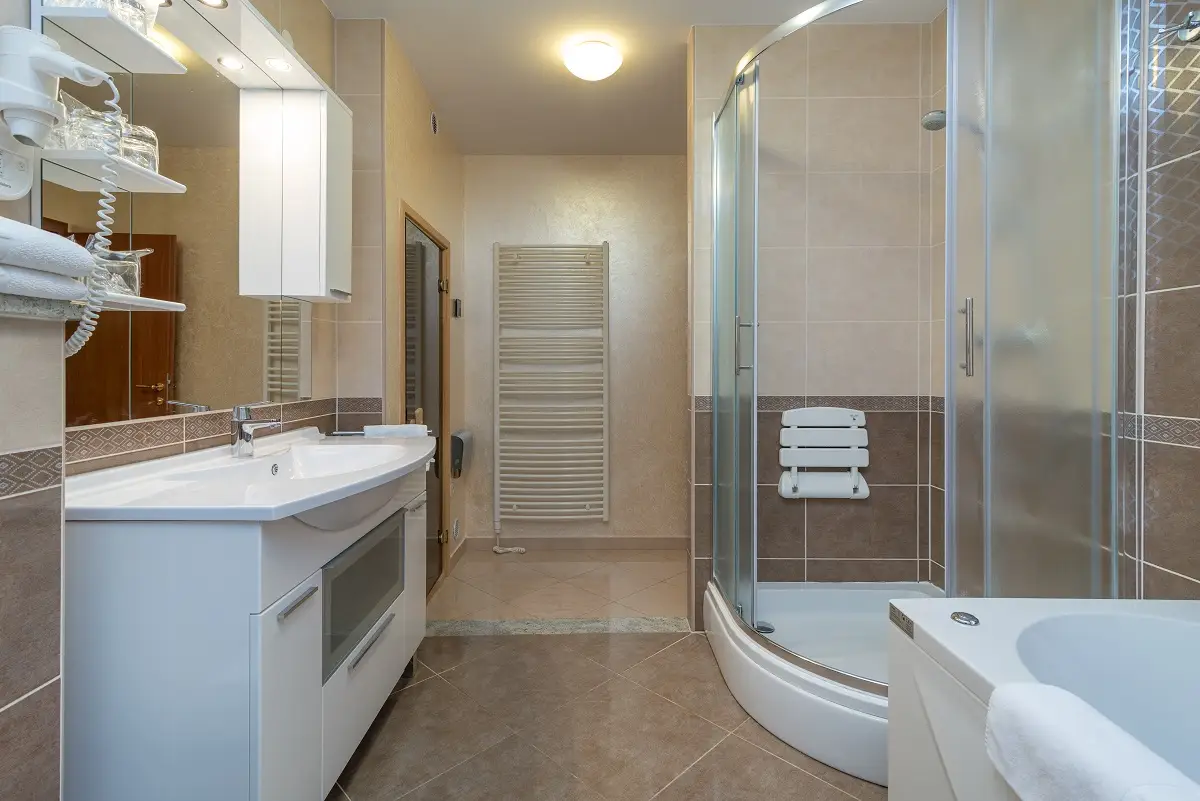 Trogir Palace bathroom with bathtub, glass shower and long vanity