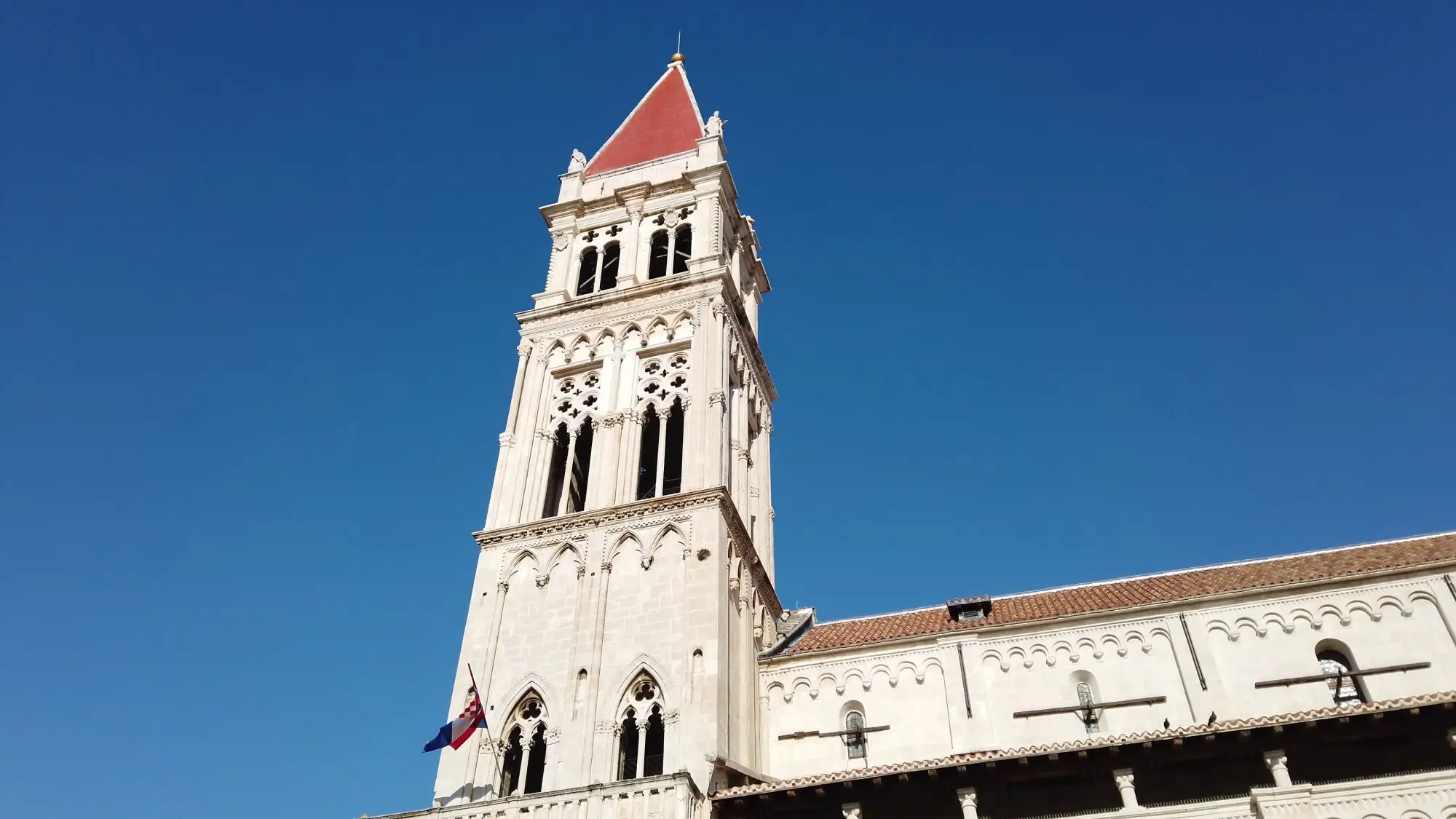 Trogir Palace cathedral bell tower against a clear blue sky
