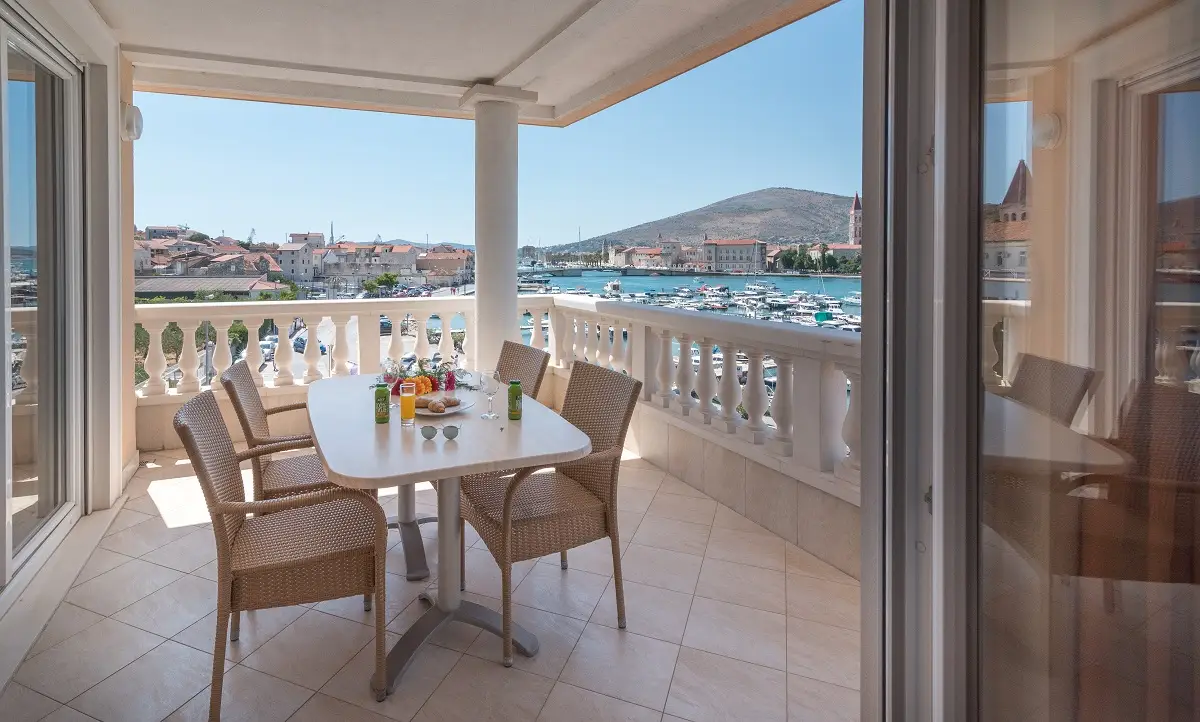 Trogir Palace balcony with dining table and harbour view