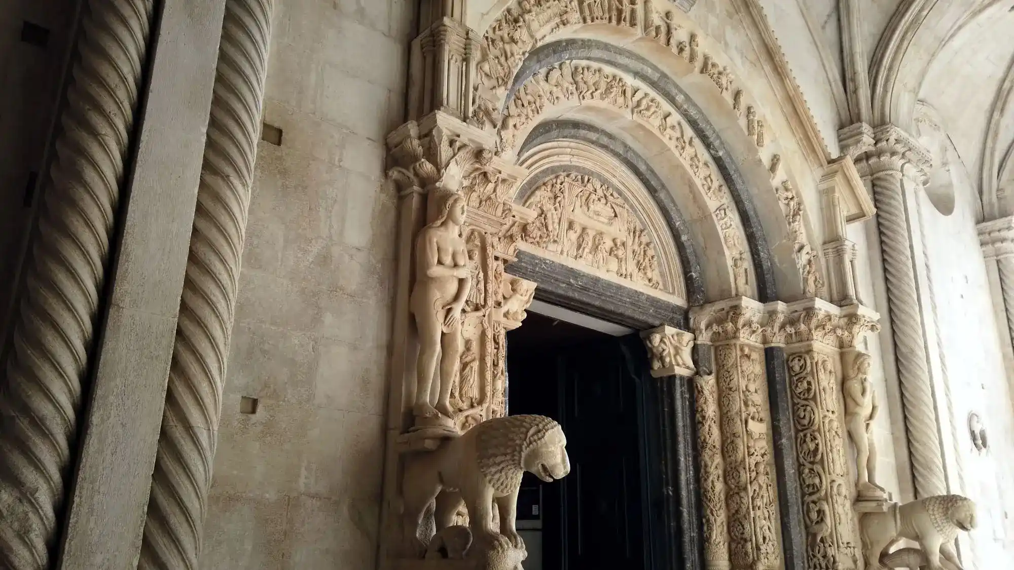 Trogir Palace carved Romanesque stone portal with lion statue