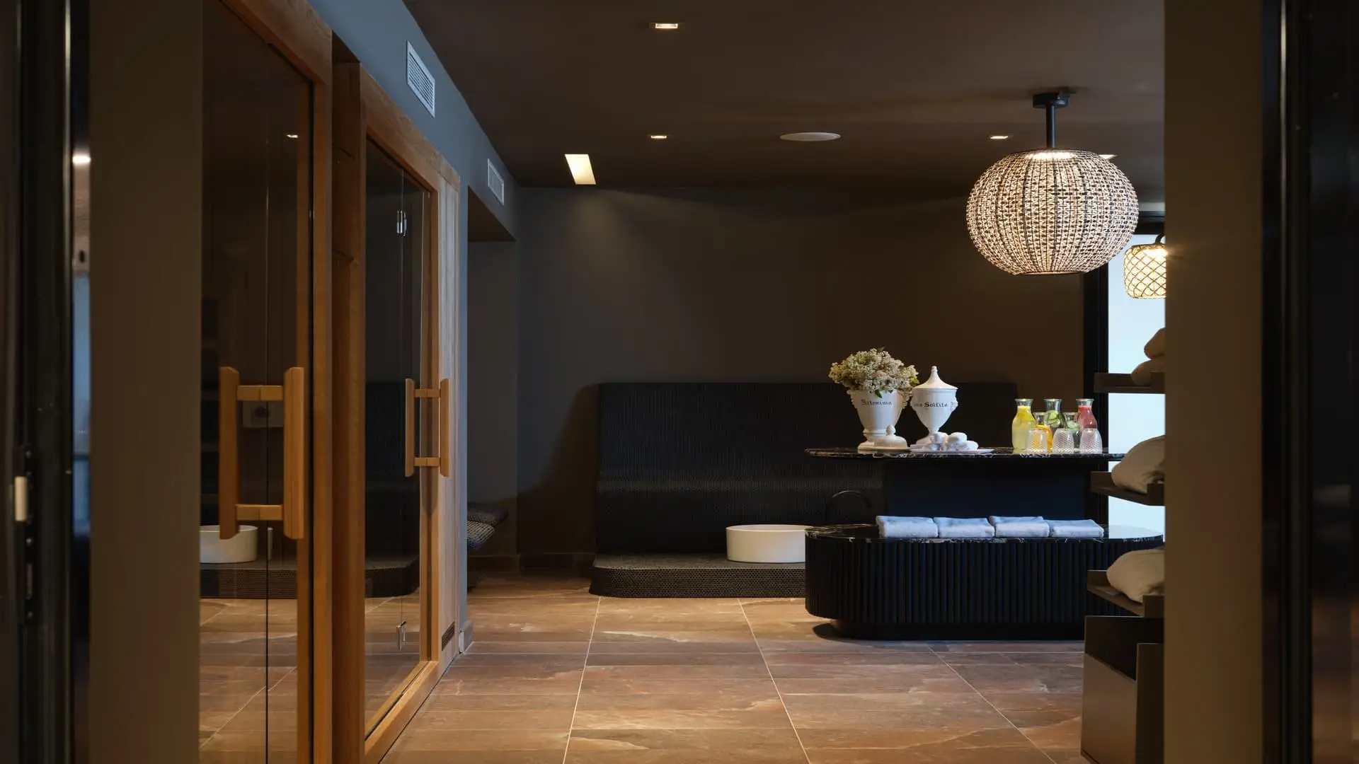 Palazzo Rainis Hotel & Spa dark relaxation room with woven pendant lamp