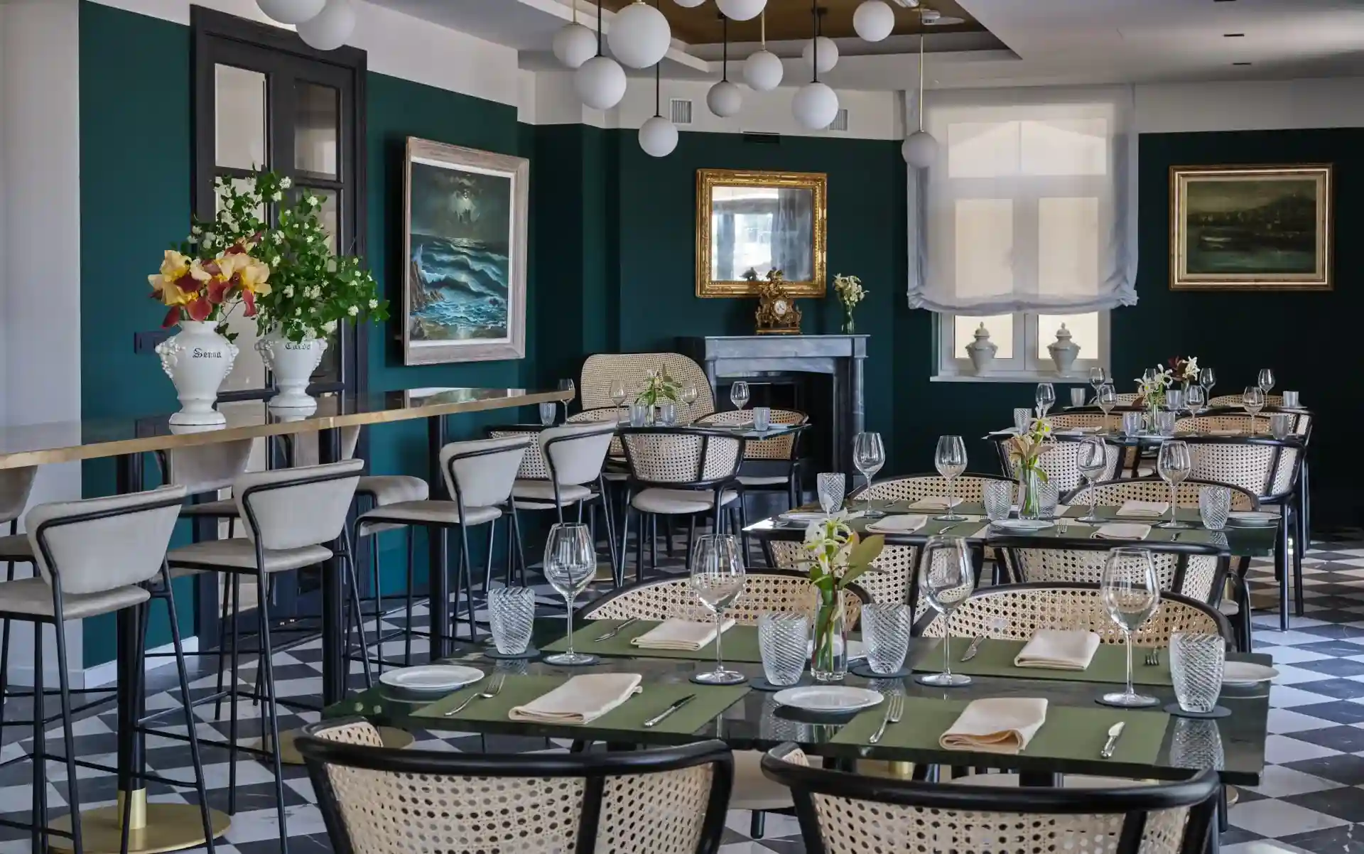 Palazzo Rainis Hotel & Spa restaurant with dark green walls and high tables