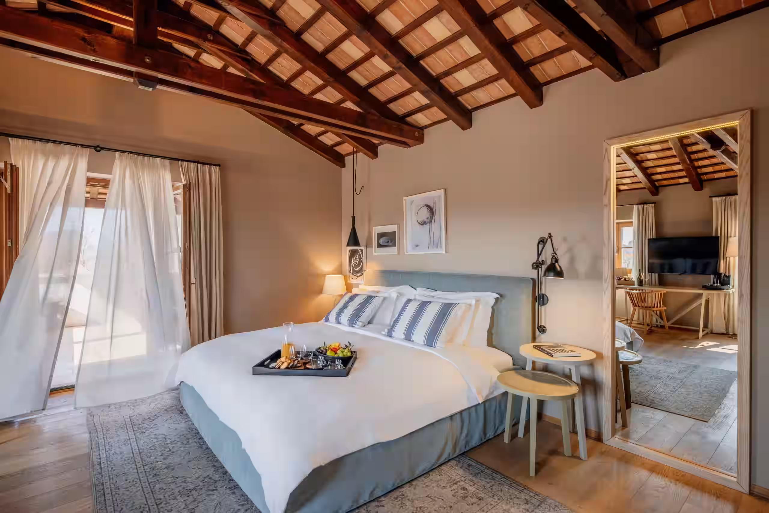 Meneghetti beamed bedroom with tray on the bed