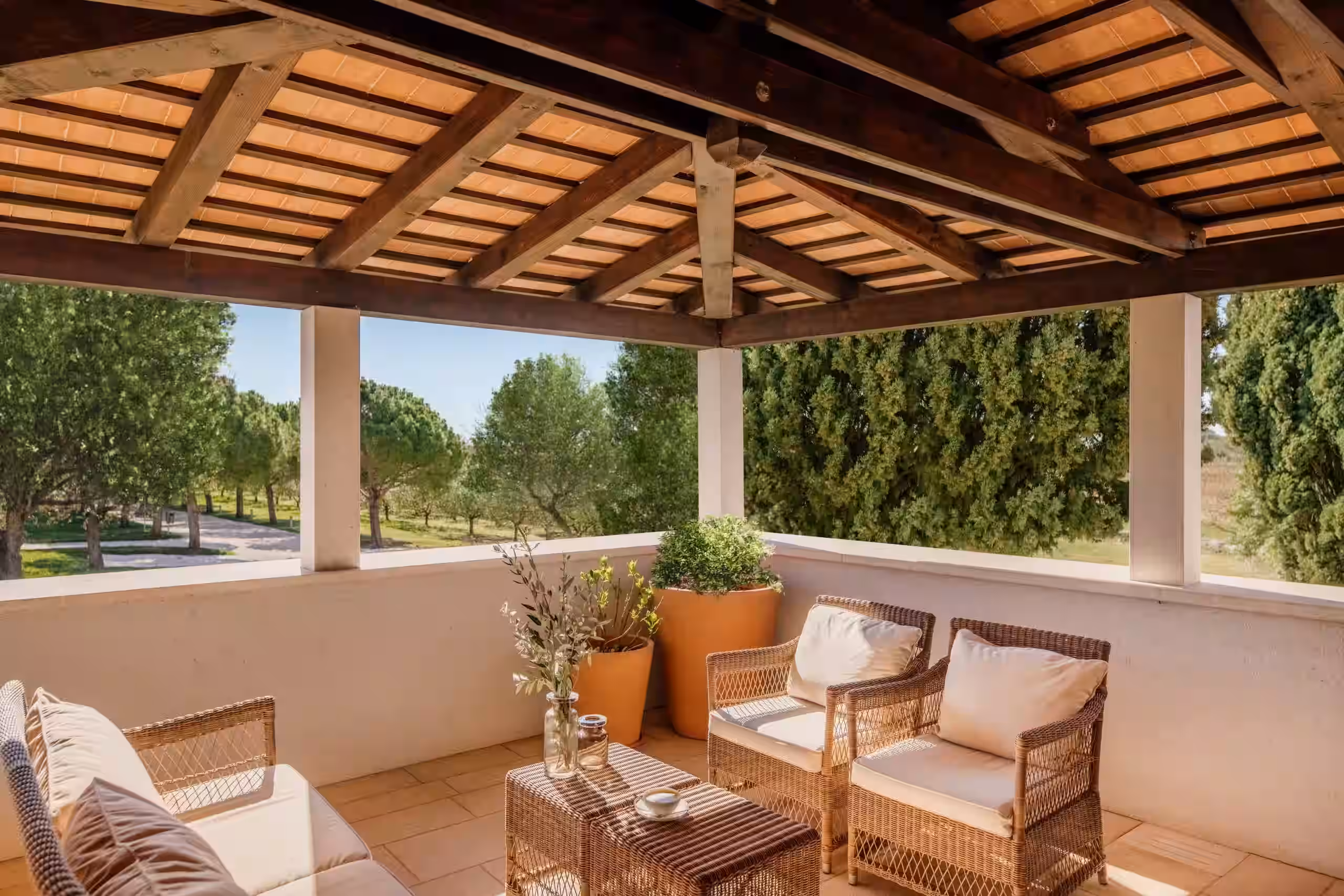 Meneghetti covered veranda with armchairs overlooking trees