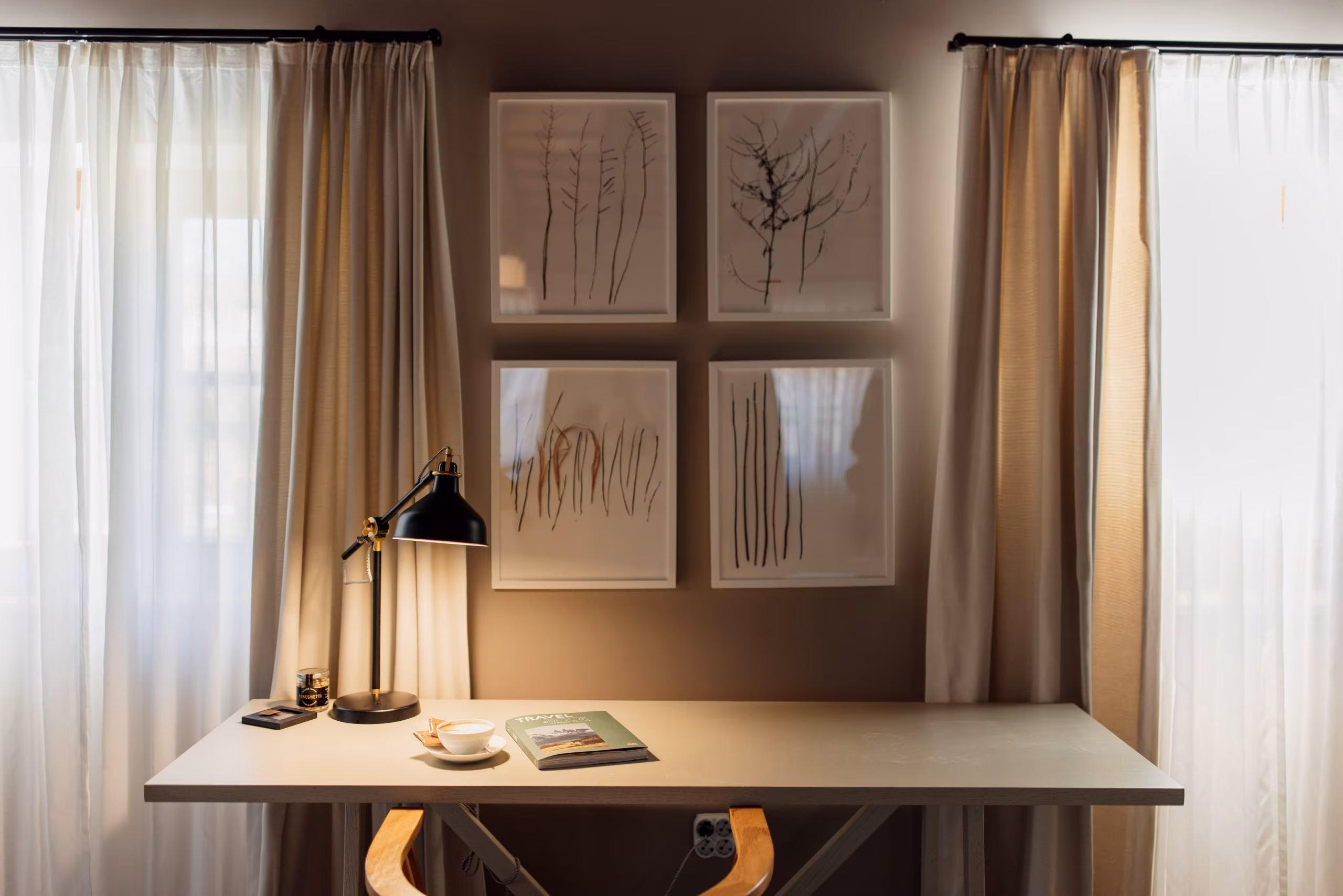Meneghetti writing desk with lamp below botanical prints