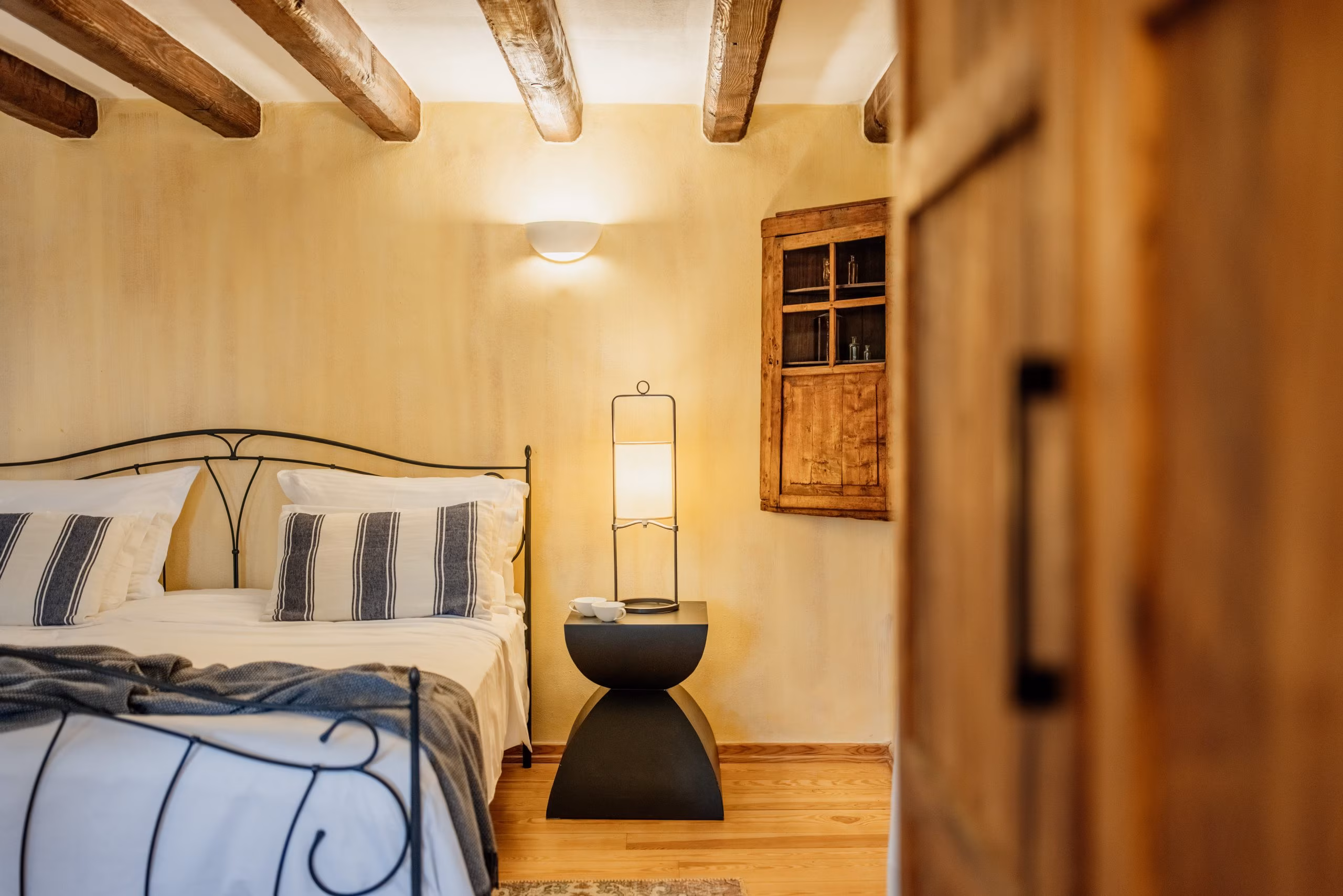 Meneghetti bedroom with striped cushions and bedside lamp