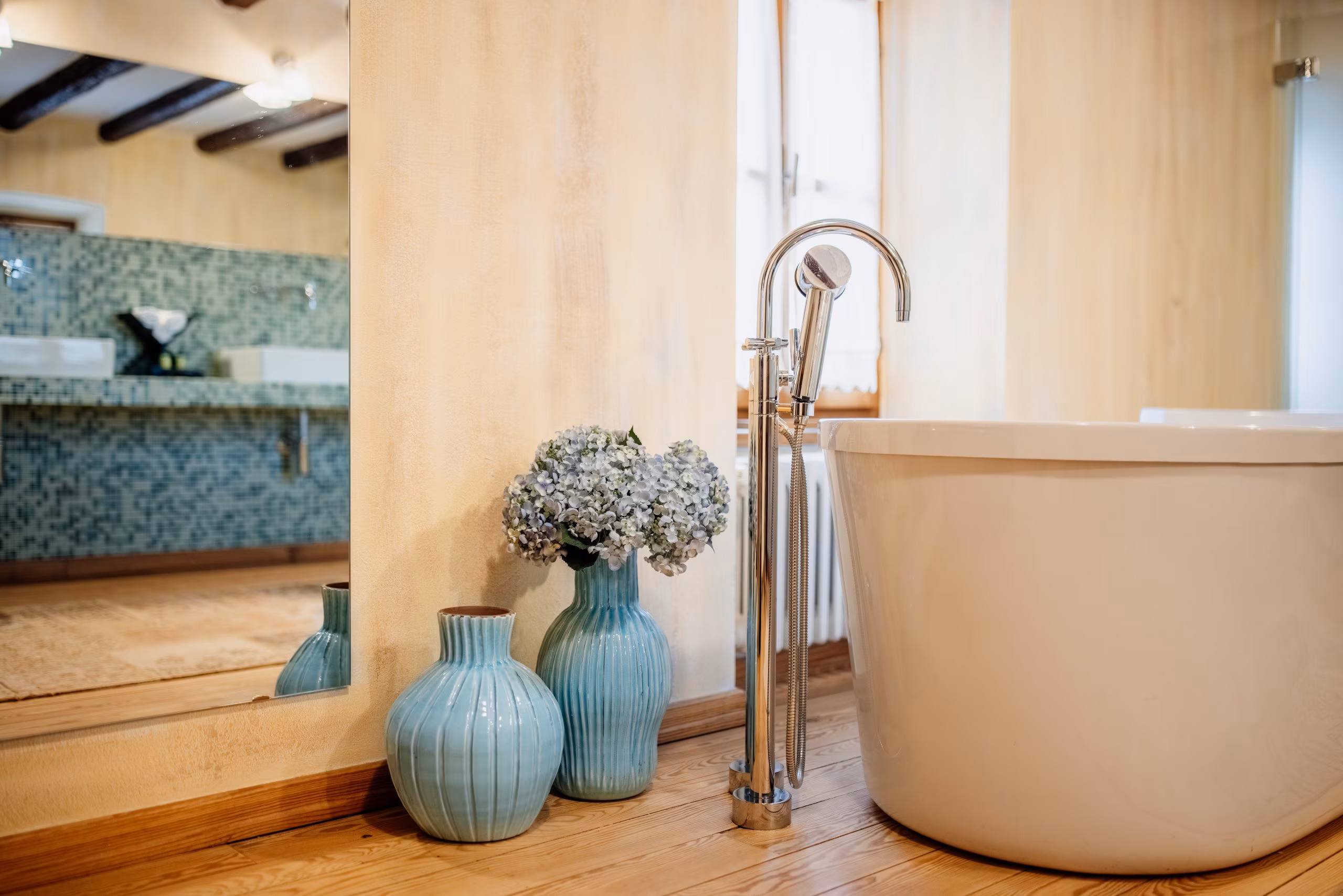 Meneghetti freestanding bath with blue vases and flowers