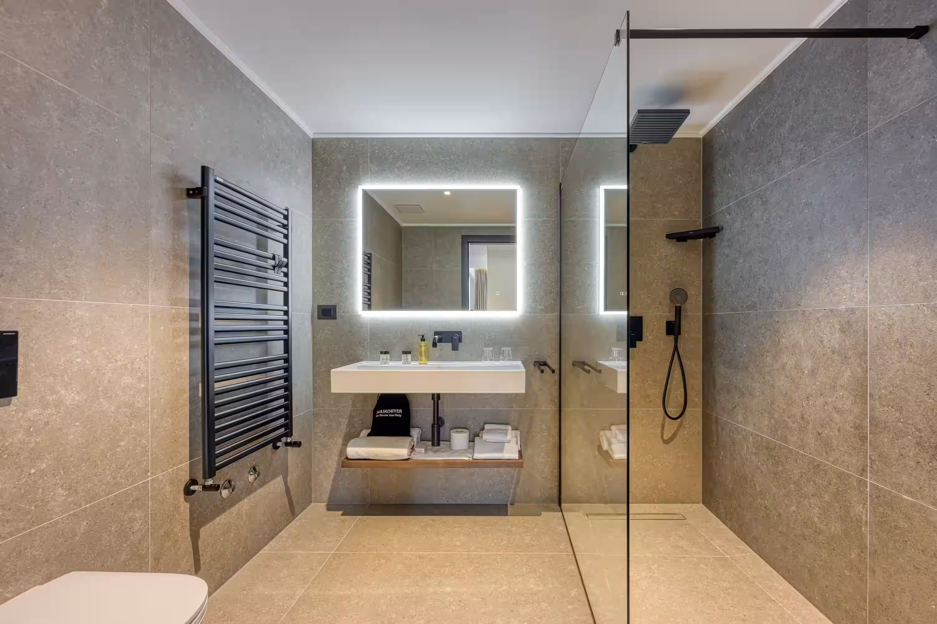 Level 5 Rovinj bathroom with backlit mirror, towel radiator and walk-in shower