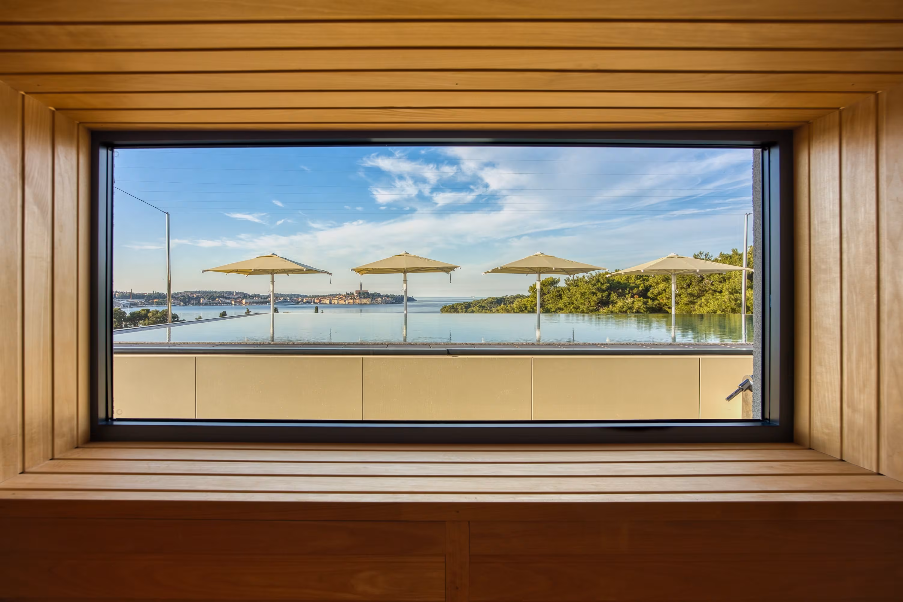 Level 5 Rovinj picture window framing the sea and parasols
