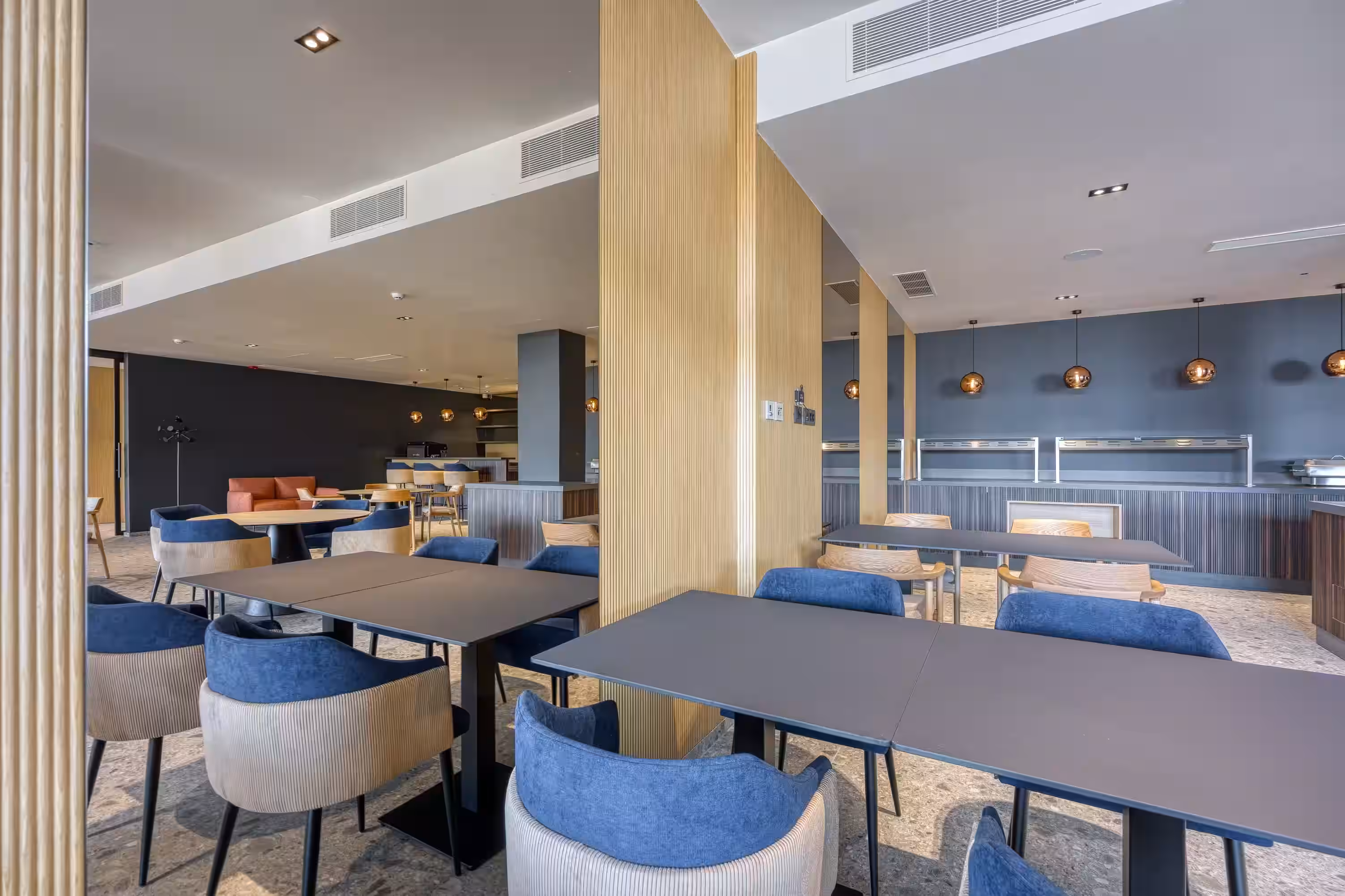 Level 5 Rovinj dining room with blue chairs and wooden pillars