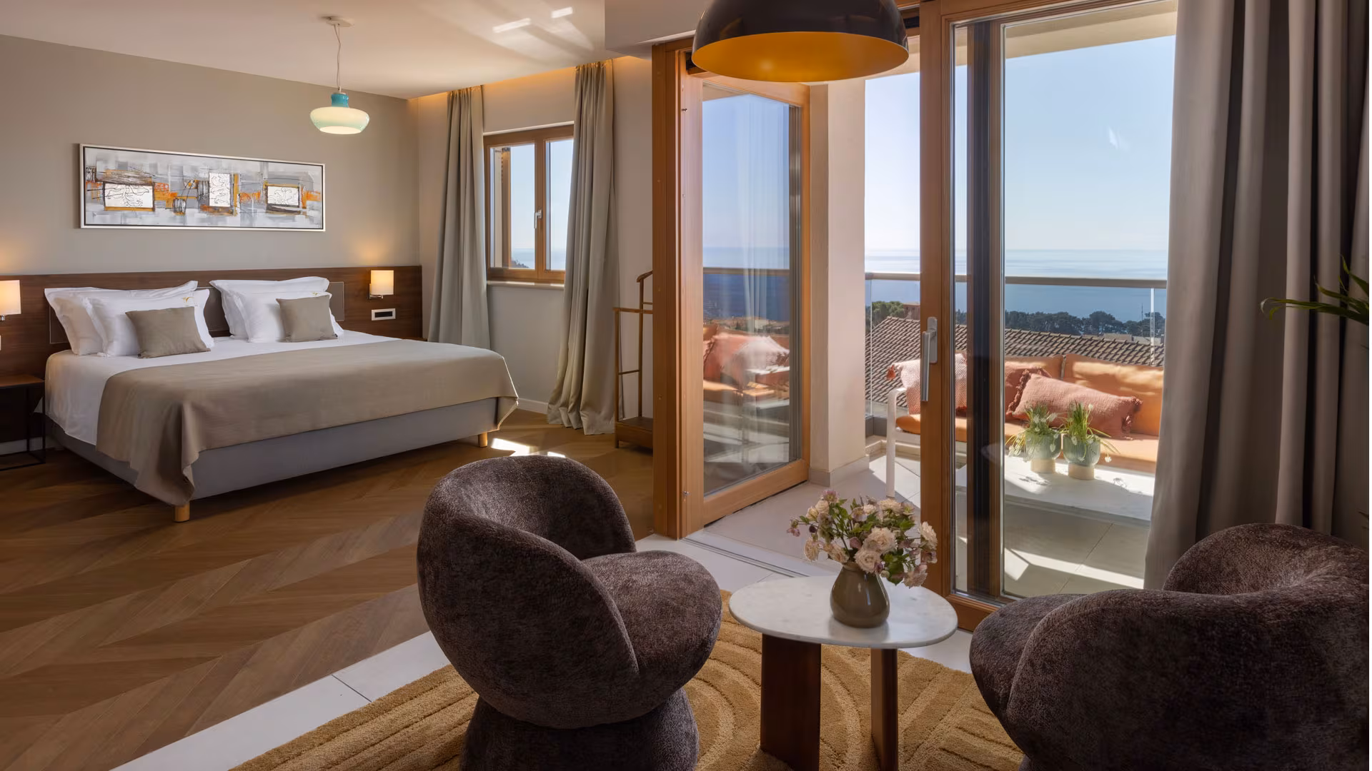Palace Natali - Dubrovnik room with dark armchairs and balcony doors onto the sea
