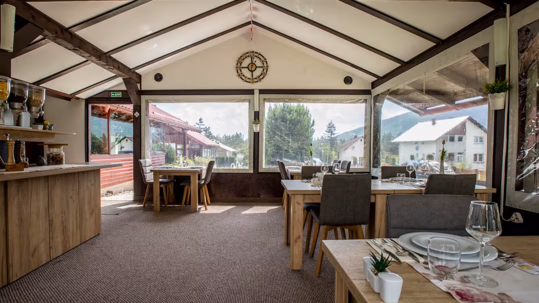 Oreskovic Guest House dining room with timber ceiling and large windows