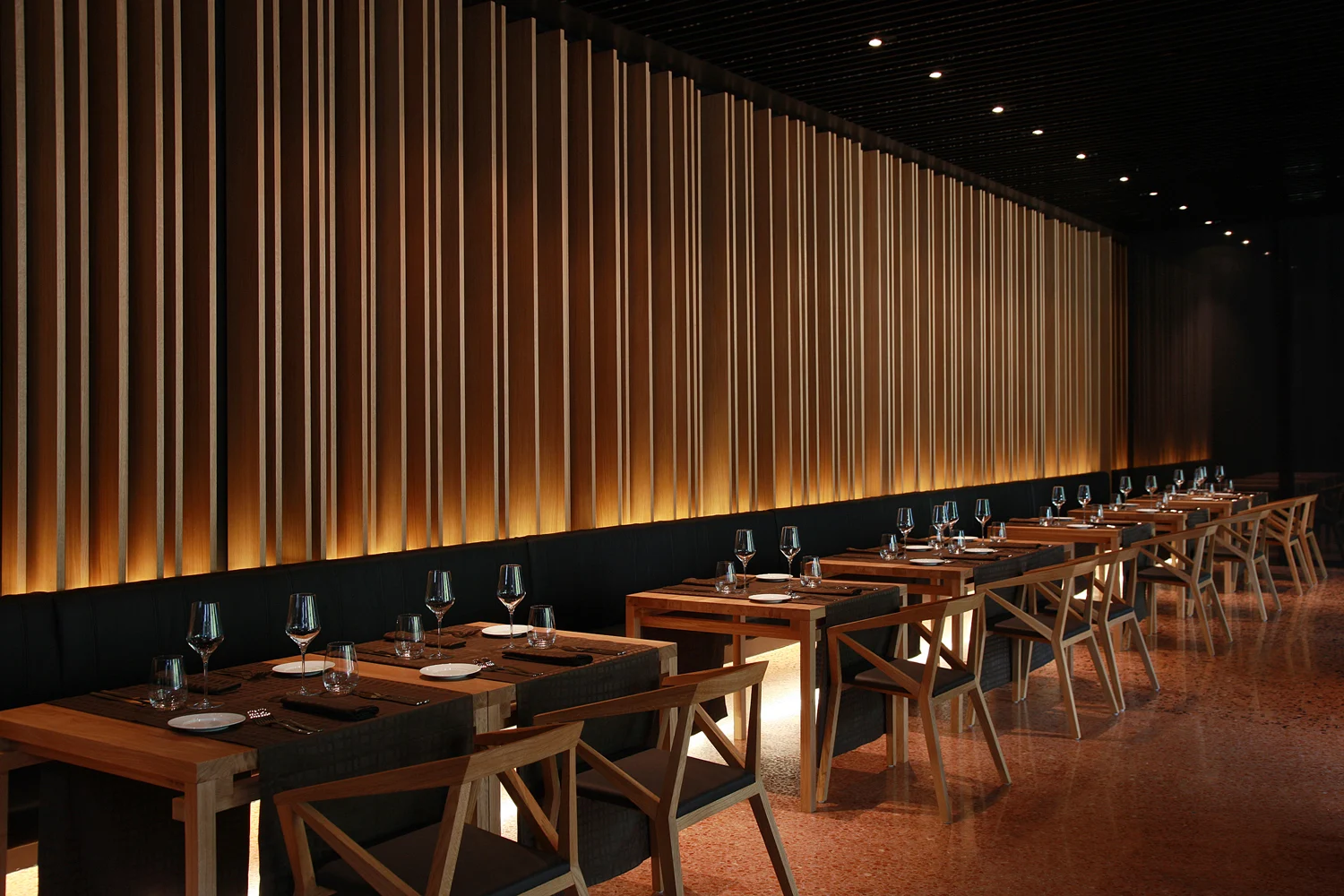 Lone restaurant with gold-lit drapes and dark tables