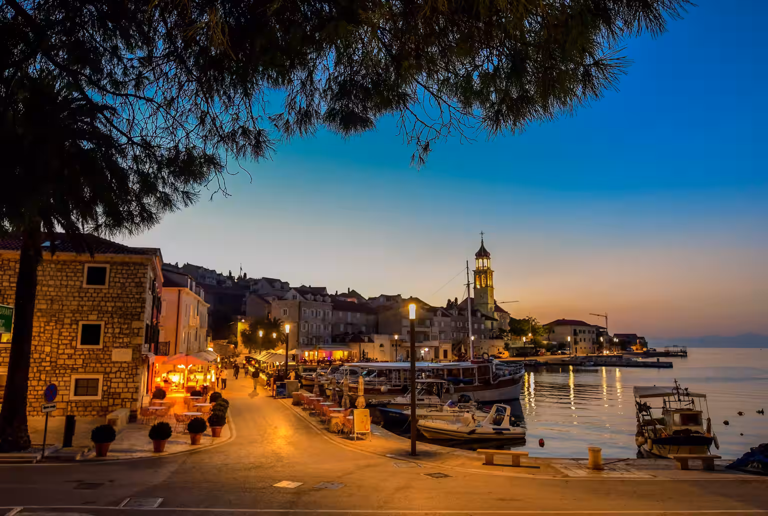 Lemongarden Boutique Hotel waterfront promenade and church tower at dusk