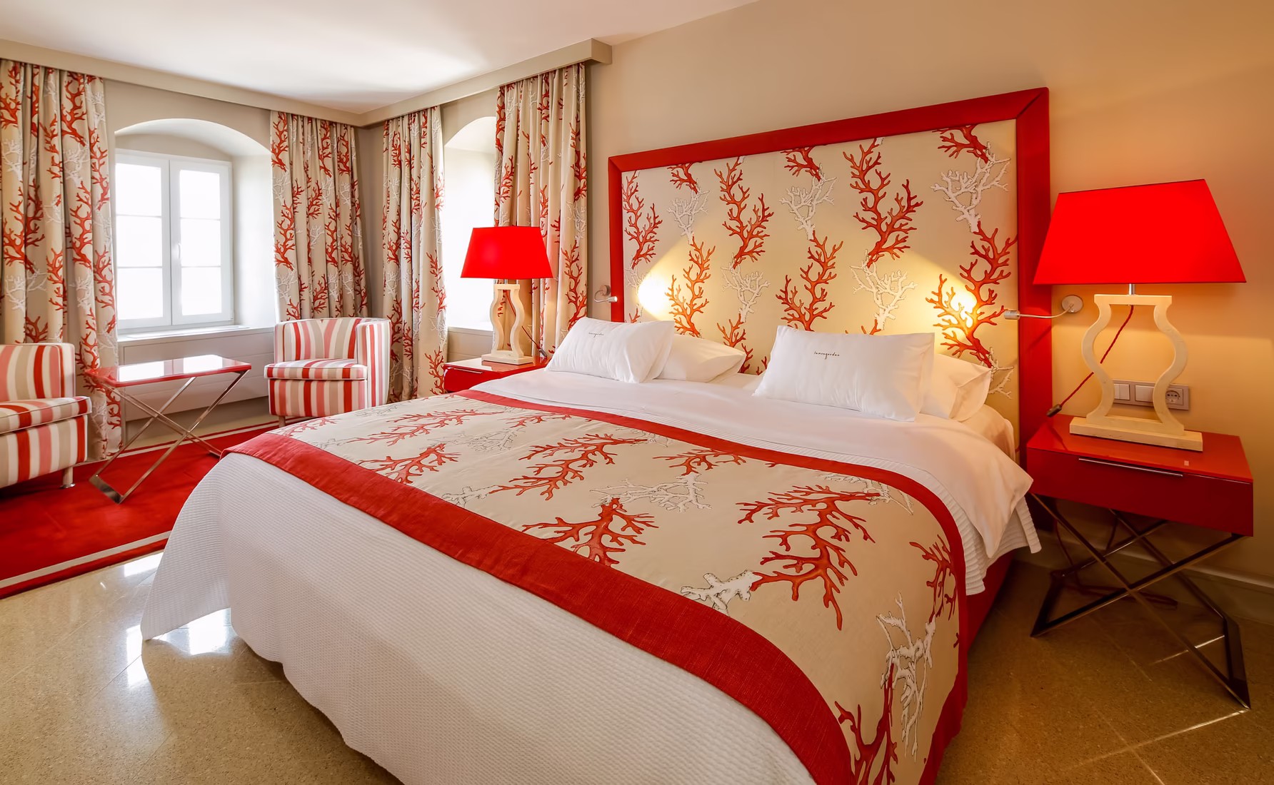 Lemongarden Boutique Hotel bedroom with red coral headboard and red patterned bedspread