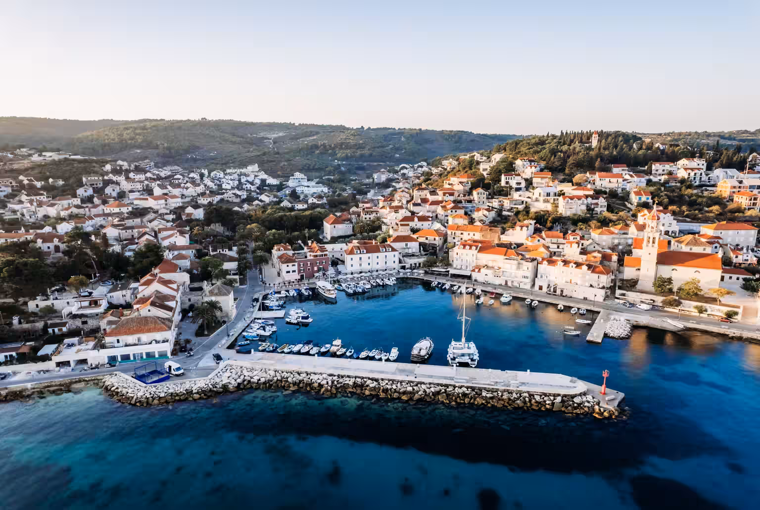 Lemongarden Boutique Hotel view over the harbour town and moored boats from above