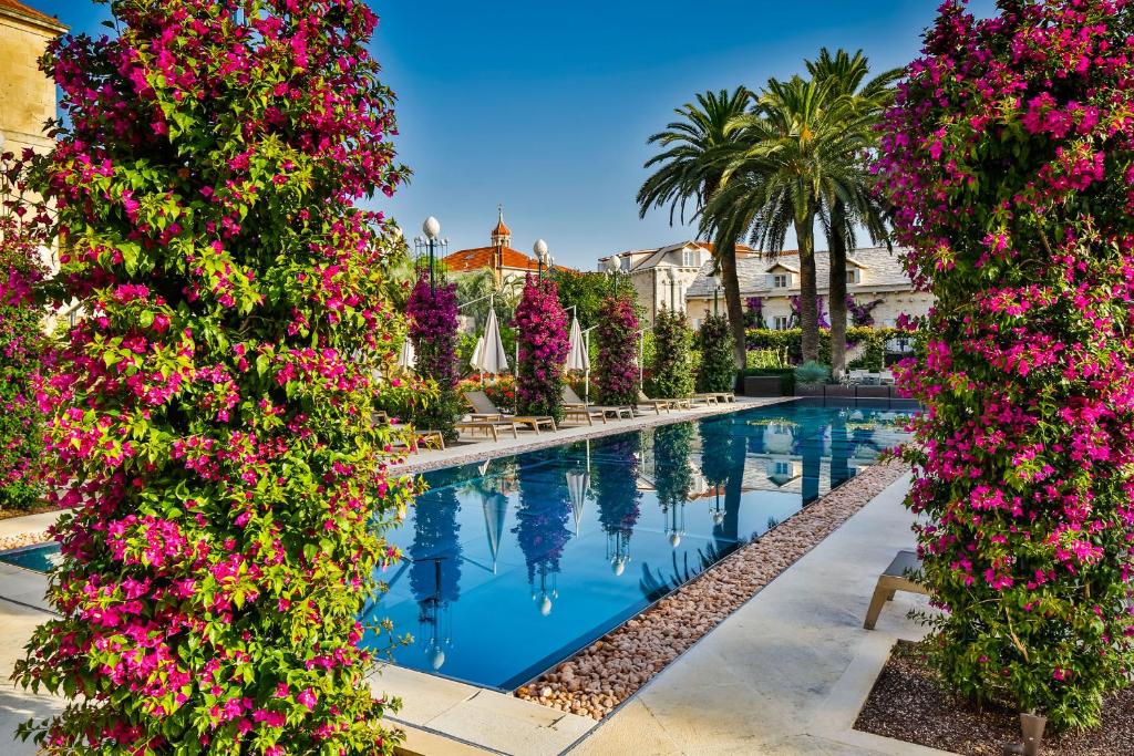 Lemongarden Boutique Hotel pool and pink bougainvillea seen from the corner of the garden