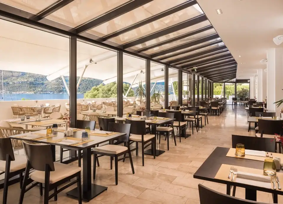 Hotel Liburna conservatory restaurant with sea views and rows of tables