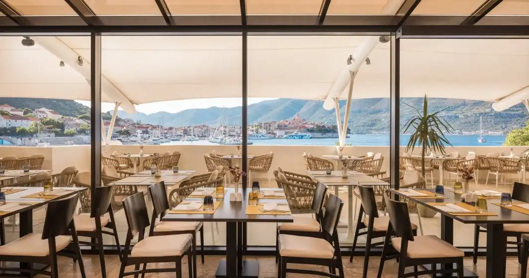 Hotel Liburna glass-walled terrace restaurant overlooking the harbour