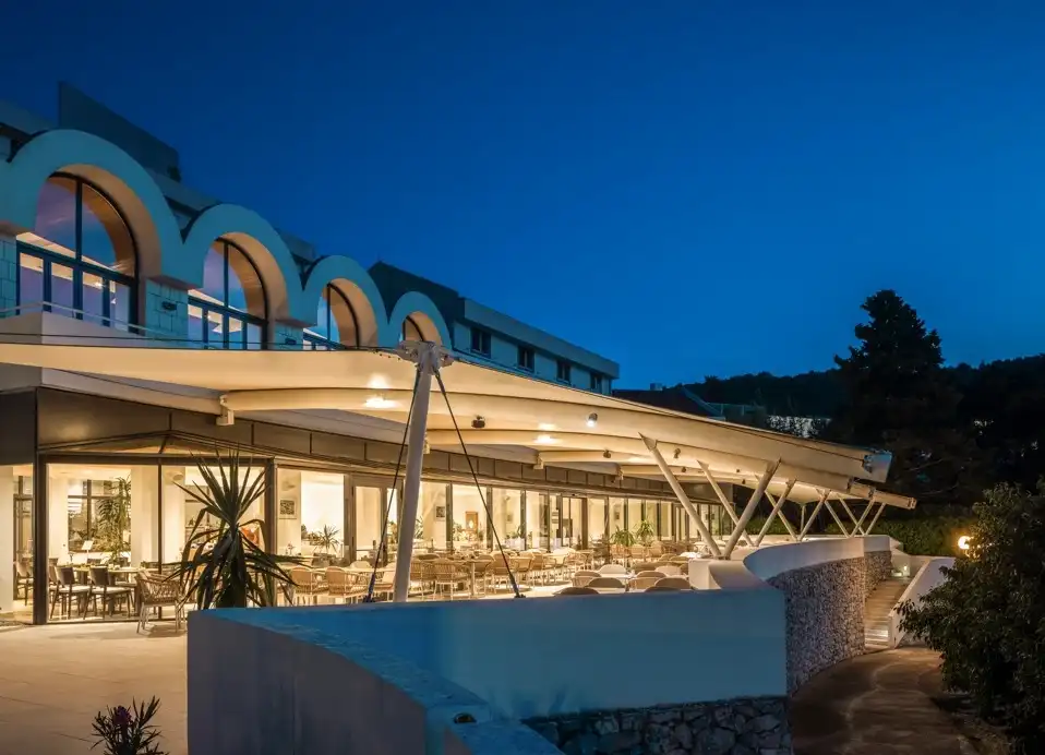 Hotel Liburna terrace restaurant under arched windows at dusk