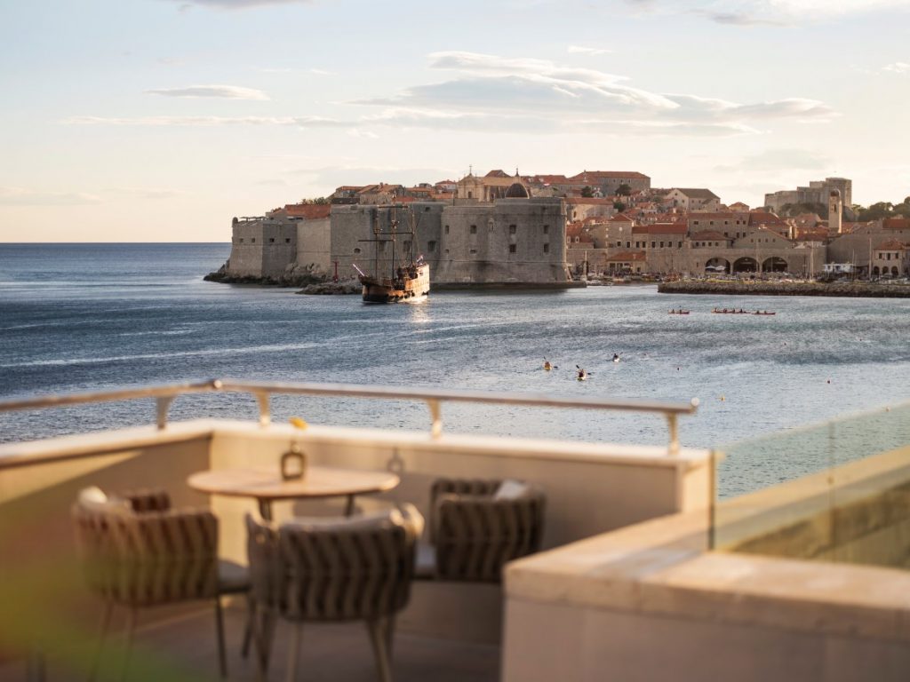 Hotel Excelsior balcony with wicker chairs facing Dubrovnik old town across the bay