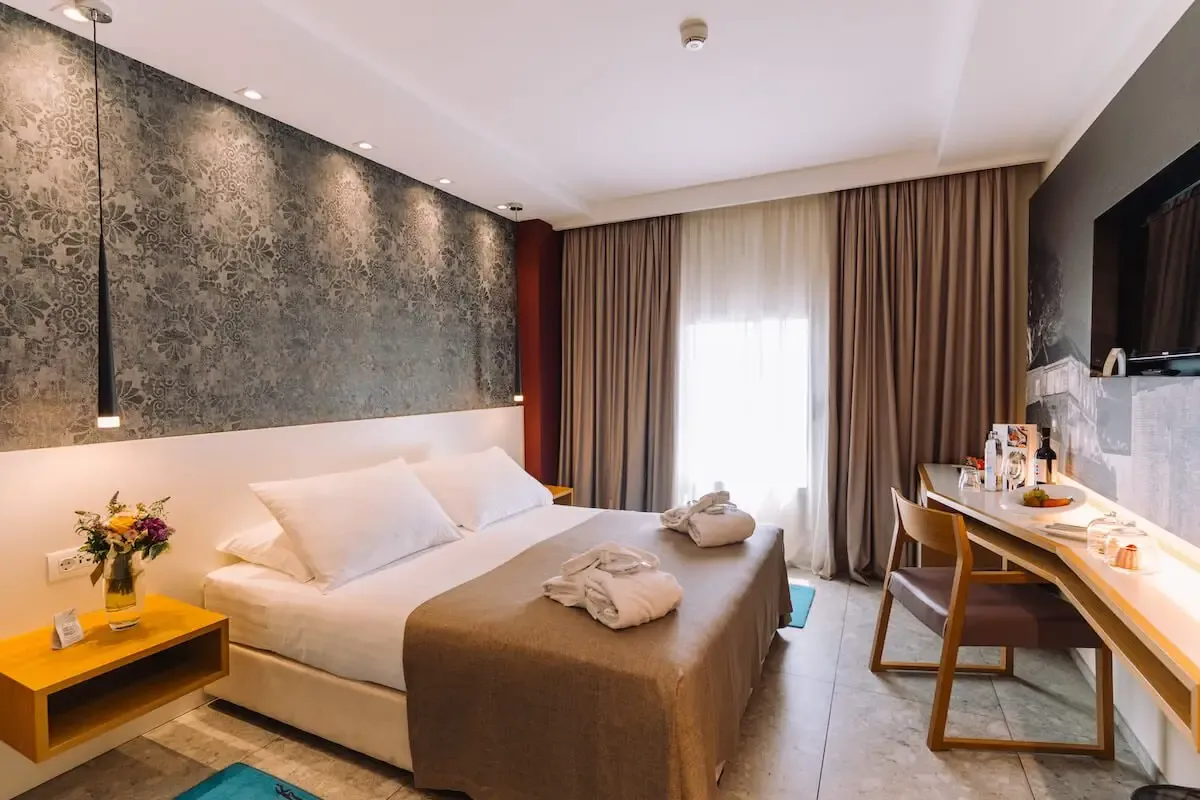 Hotel Lero, Dubrovnik double bedroom with dressing gown on the bed and desk