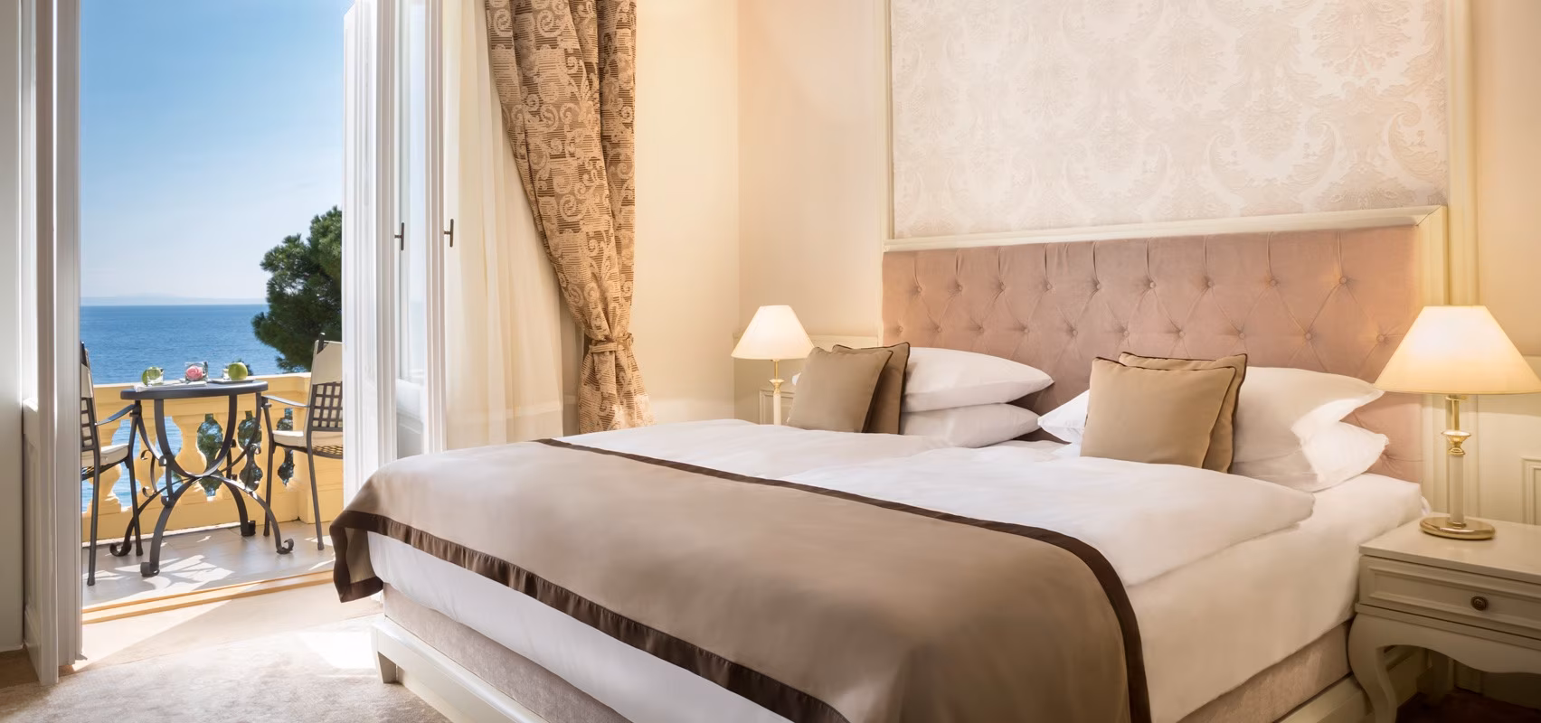 Hotel Kvarner double bedroom with tufted headboard and draped curtains