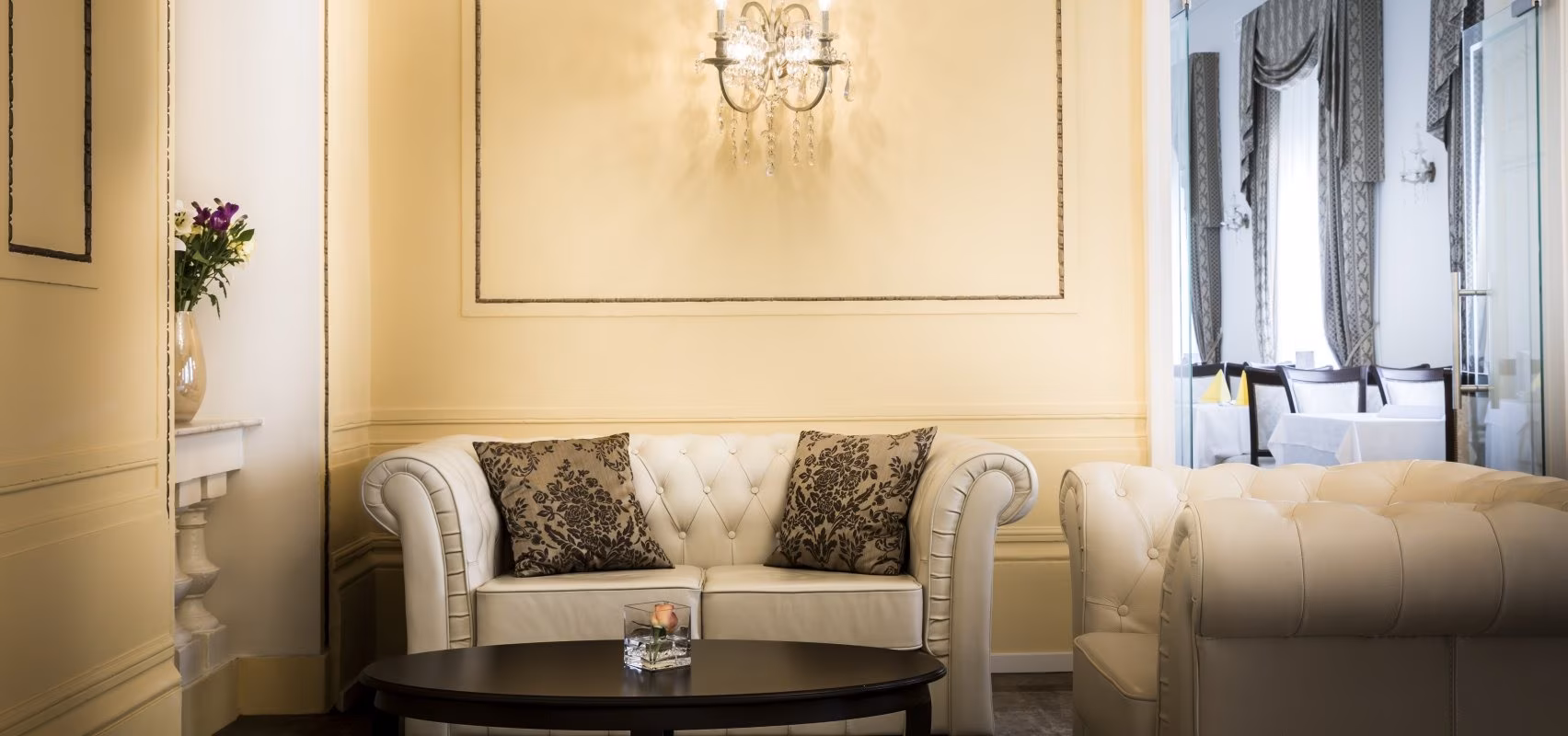 Hotel Kvarner lounge with tufted white sofa and wall sconce