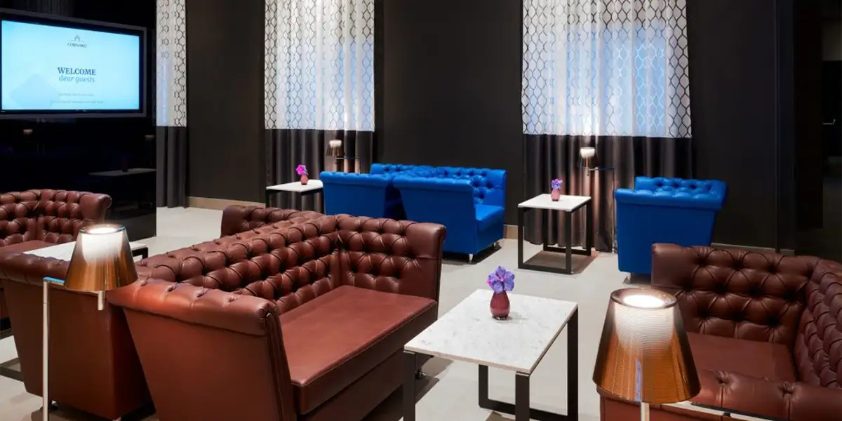 Hotel Cornaro lounge with chesterfield sofa and blue velvet sofas