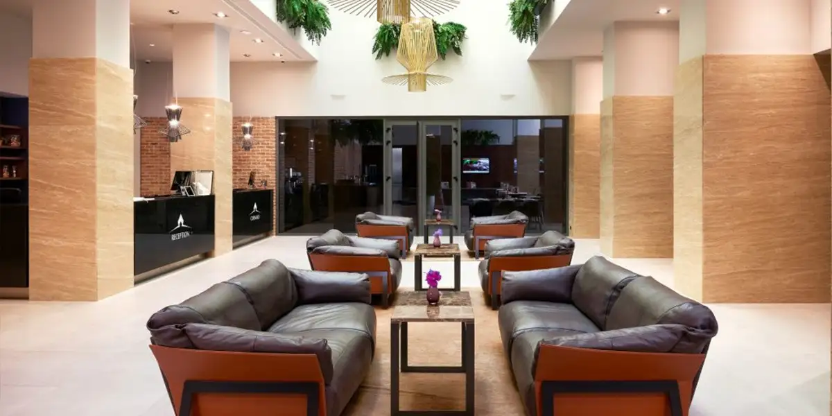 Hotel Cornaro lobby with leather sofas and hanging plants