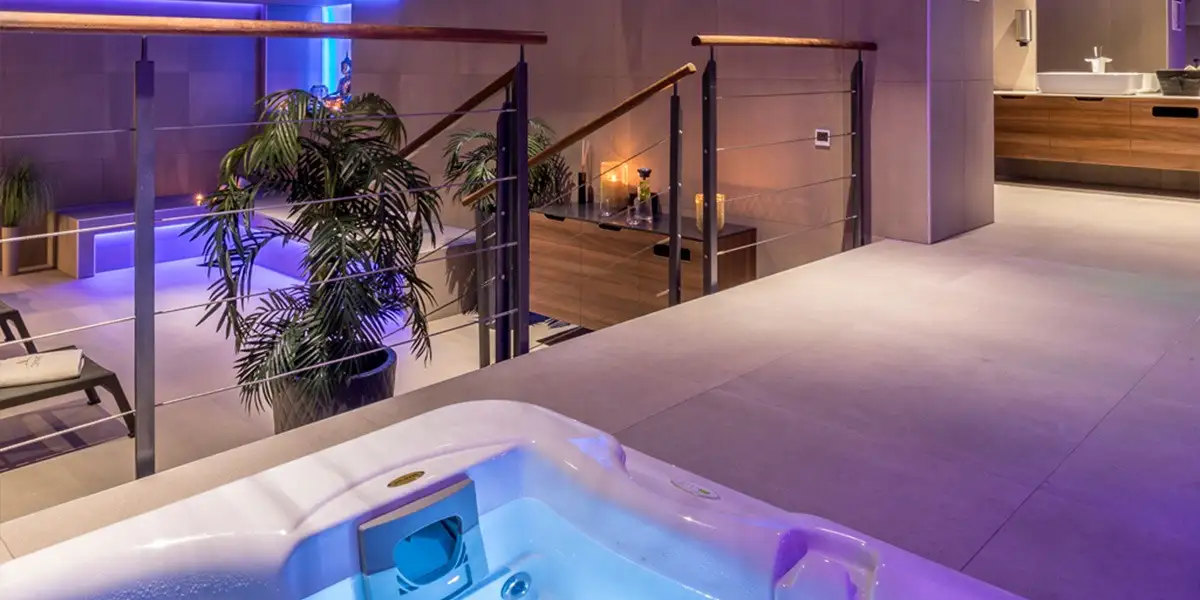 Hotel Cornaro hot tub with purple lighting and potted palm