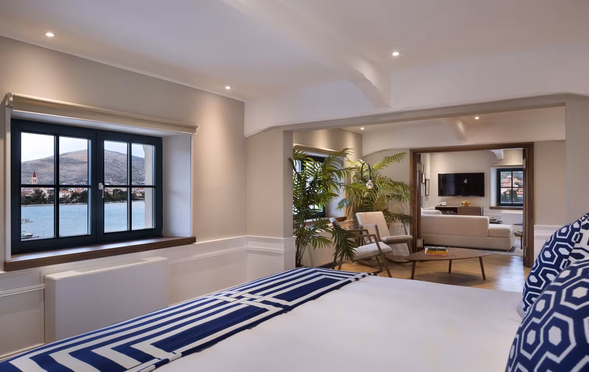 Brown Beach House Design Hotel lounge with steel-framed windows, plants and striped rug