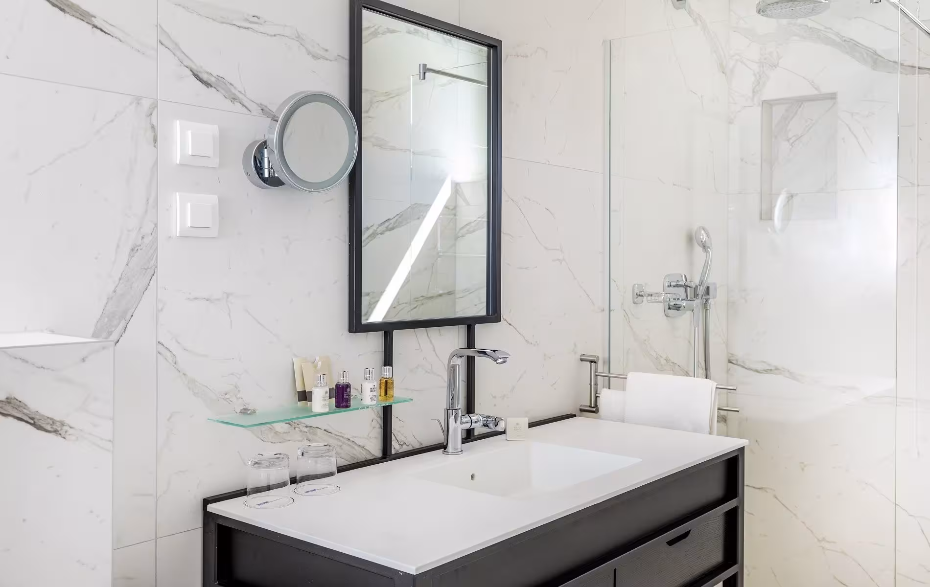 Brown Beach House Design Hotel marble bathroom with black-framed mirror and basin