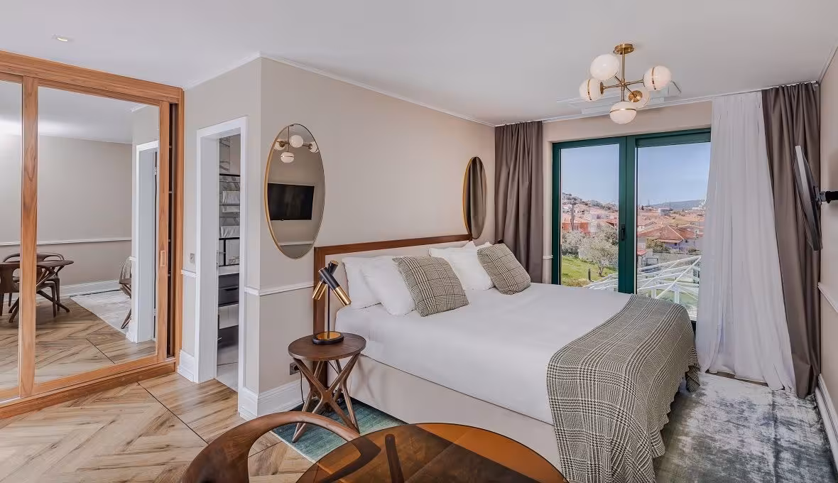 Brown Beach House Design Hotel bedroom with chandelier, upholstered bed and window
